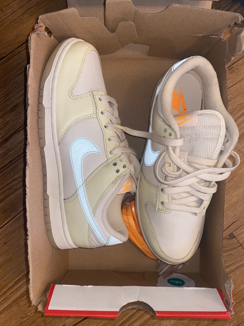 Nike Low Top Sneakers in Beige with White Swoosh and Orange Accent